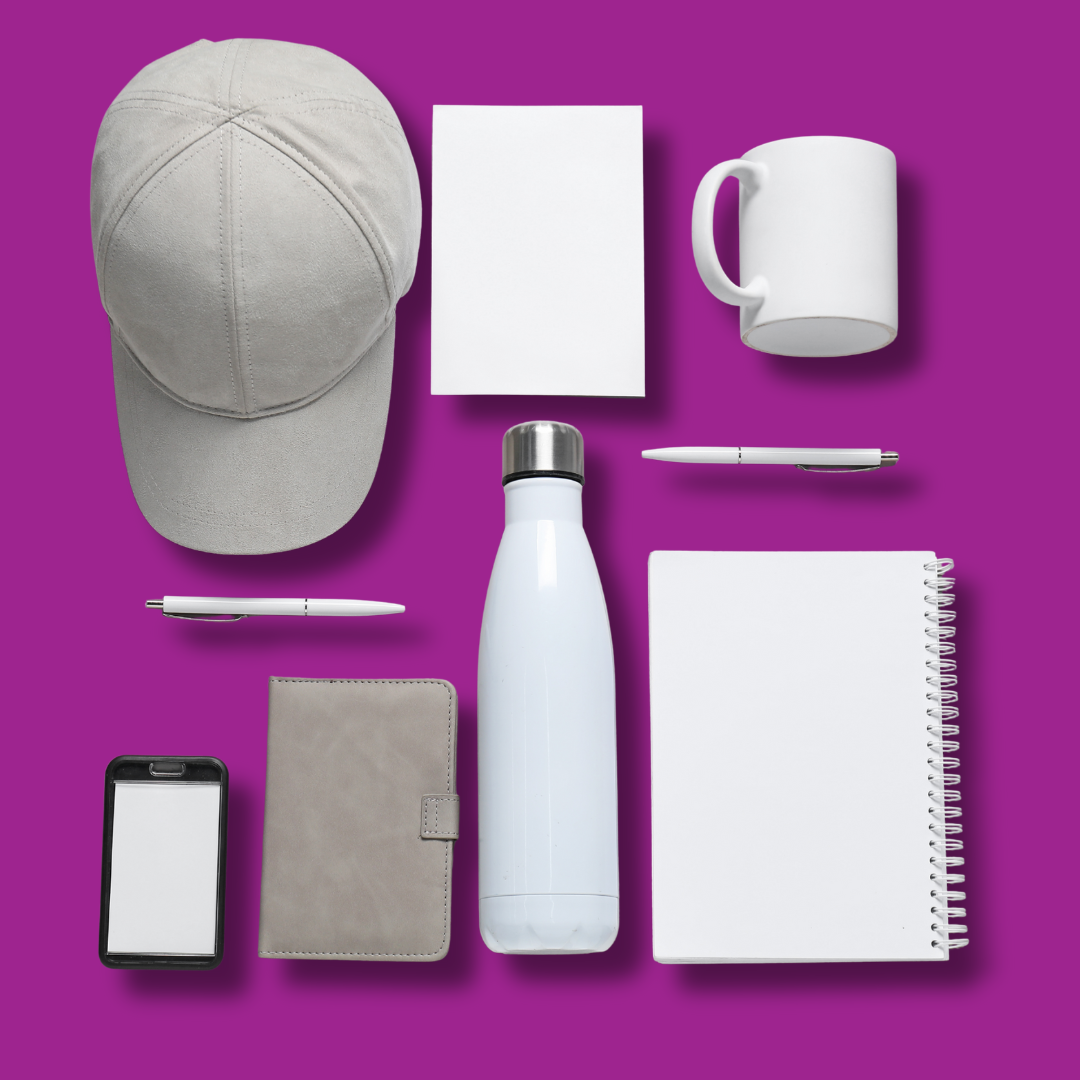 Group shot or flat lay of multiple promo categories together (pens, bottles, caps, tote bags, tech accessories)
