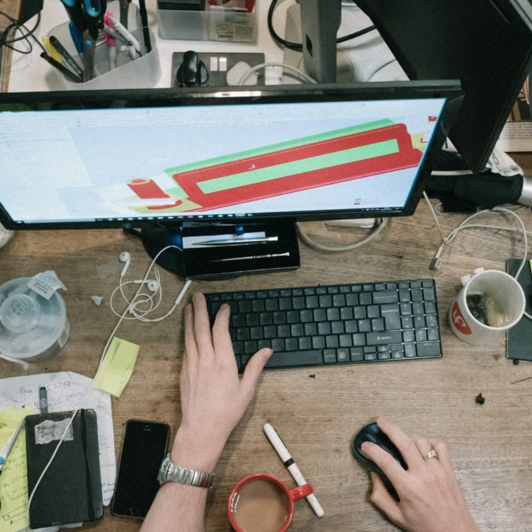 Graphic designer workspace with logo on screen, and logo design in a laptop